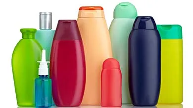 Assorted colorful plastic personal care bottles on a white background.